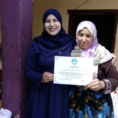 Women holding a certificate together