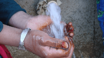 Hands cupping water