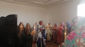 Women holding candles