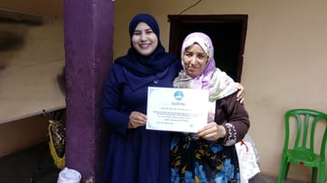 Women holding a certificate together