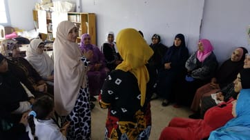 Two women speaking to each other