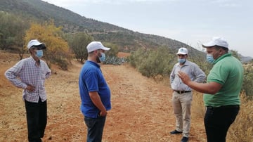 Local Volunteer Hicham in green t shirt in the field