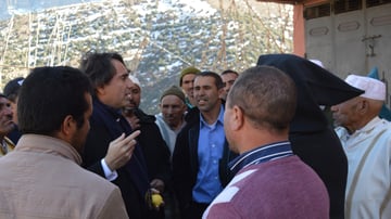 Yossef speaking with a group