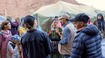 Woman speaking with haf volunteers