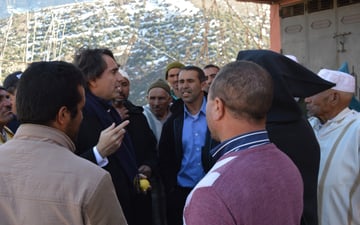 Yossef speaking with a group