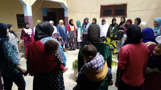 Women holding hands in a circle
