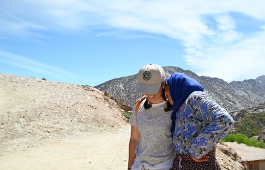 Two people smiling arms around each other